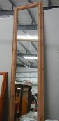 A tall pine framed mirror.