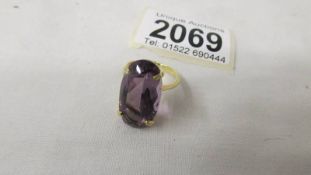 An amethyst oval stone ring in 18ct gold, 5.9 grams in total, size K.