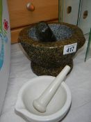 A Granite pestle and mortar and one other.