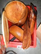 A box of wooden items including bowls etc.