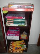 Four shelves of assorted games.