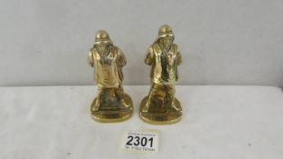 A pair of old brass matchstriker's in the form of fishermen