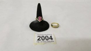 A silver gilt ring marked 925, size N together with an unmarked stone set yellow metal ring, size M.