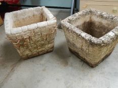 A pair of square garden planters.