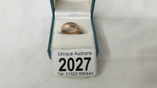 A gold wedding ring marked 585 (14k), size L half.