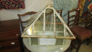 A Victorian cast iron and glass terrerium, in two parts.