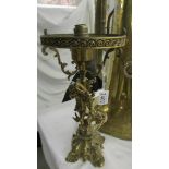 A heavy brass cherub table lamp (in need of re-wiring).