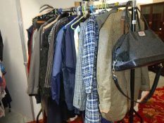 A rail of assorted clothing including coats, jackets, shirts etc., (some vintage).