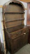 An oak arched top dresser with linenfold doors.