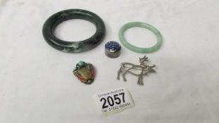 A jade bangle, another bangle, a silver deer brooch,