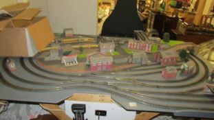 A model railway layout on fixed base with track, buildings, controls, accessories etc.