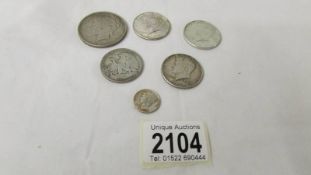 A U.S.A 1923 dollar, four half dollars and a dime.