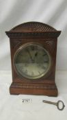 A good oak cased 8 day mantel clock with brass dial, in good working order.