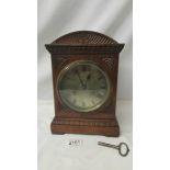 A good oak cased 8 day mantel clock with brass dial, in good working order.