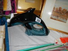 A blue Poole dolphin figure.