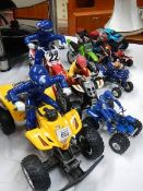 A quantity of toy quad bikes and toy motor bikes.