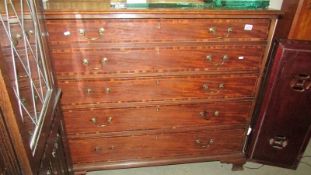 A large five drawer mahogany inlaid secretaire chest with brass drop handles.