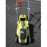 A Ryobi electric lawn mower.