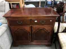 A dark wood stained cupboard 2 drawers, 2 doors,