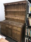 An old antique pine dresser Height 205cm, width 152cm,