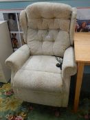 An electric reclining arm chair in working order.