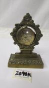 An old brass pocket watch stand and a compass.