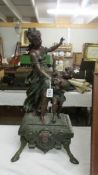 A bronzed effect composite dancing figure of a mother and child, 62 cm tall.