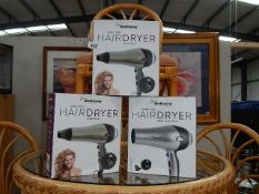 Three boxed Paul Anthony hair dryers.