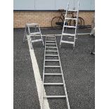 An aluminium ladder and 2 aluminium step ladders.