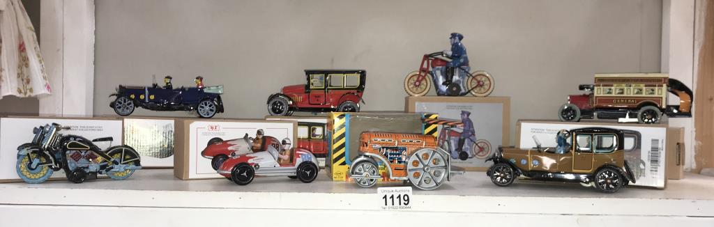 8 boxed re-issue tin plate clockwork toys including motorbikes, bus 7 taxi etc.