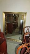 A gilt framed bevel edged mirror. 139 x 107 cm.