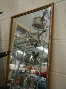 A gilt framed mirror.