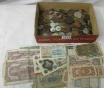 A mixed lot of old coins and bank notes.