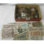 A mixed lot of old coins and bank notes.