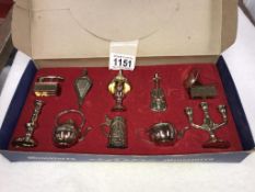 A vintage box set of brass miniatures of gramophone, oil lamp & violin bellows etc.