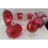 Six items of cranberry glass including pair of vases, single vase, lidded pot etc.