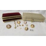 5 cameo brooches, 4 cameo pendants, a pair of cameo earrings and 2 good quality jewellery boxes.