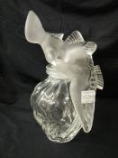 A lalique Nina Rici L'Air Du Temps perfume display bottle marked Lalique with a pair of doves as