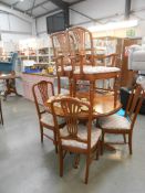 A round dark wood stained dining table and 6 chairs, diameter 108cm,