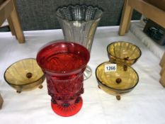 A 6.5" high deep red pressed glass vase with flower design pattern, a 8.