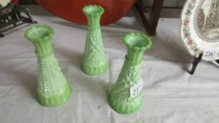 Three 6" pressed green glass spill vases.