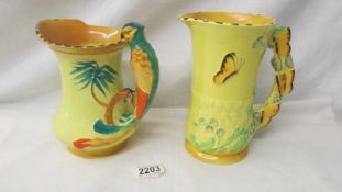 Two Burleigh pottery jugs - one with parrot handle and the other decorated with a butterfly.