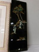 An oriental panel depicting 2 females, 2 trees and plants, overlaid and painted, 30 x 92 cm.