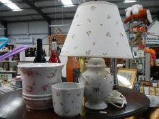 A table lamp with 2 matching pots.