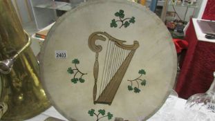 An Irish drum with drum stick.