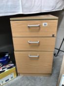 A 3 drawer pine effect bedside chest.
