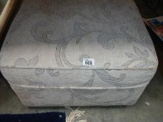 A large upholstered stool.