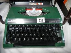 A Silver Reed 'Silverette' portable typewriter in green,.