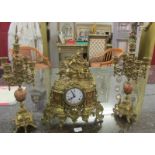 A good quality three piece brass clock garniture, the clock surmounted with horse and rider.