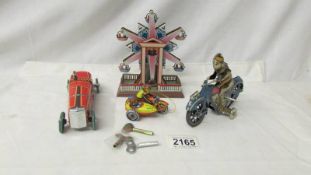 A tin plate ferris wheel in working order, and 3 other tin plate toys a/f.